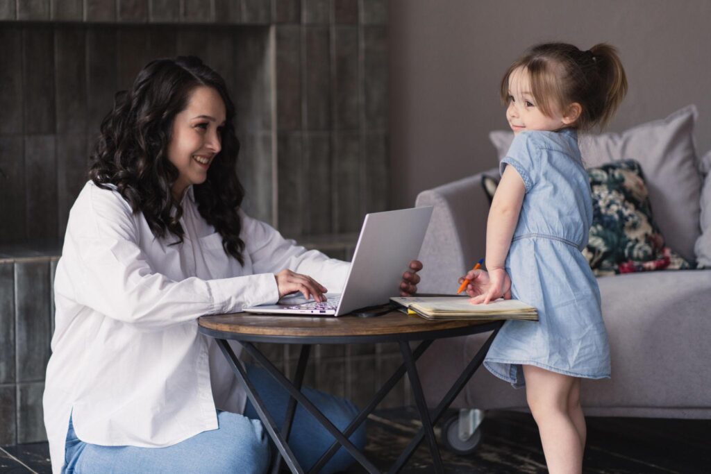 freelance writing side hustle from home for moms showing a mom working on a laptop creating blog posts and online content as a flexible work from home job that allows moms to earn income on their own schedule while balancing family life and responsibilities