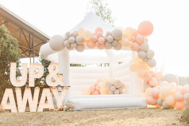 luxury white bounce house rental setup for wedding and high end party events niche bounce house themes