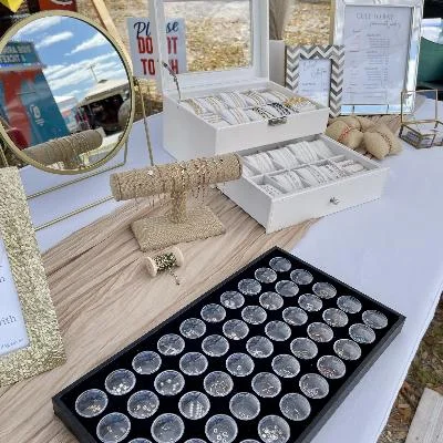 Mobile permanent jewelry business pop up setup with welding bracelet and clean display